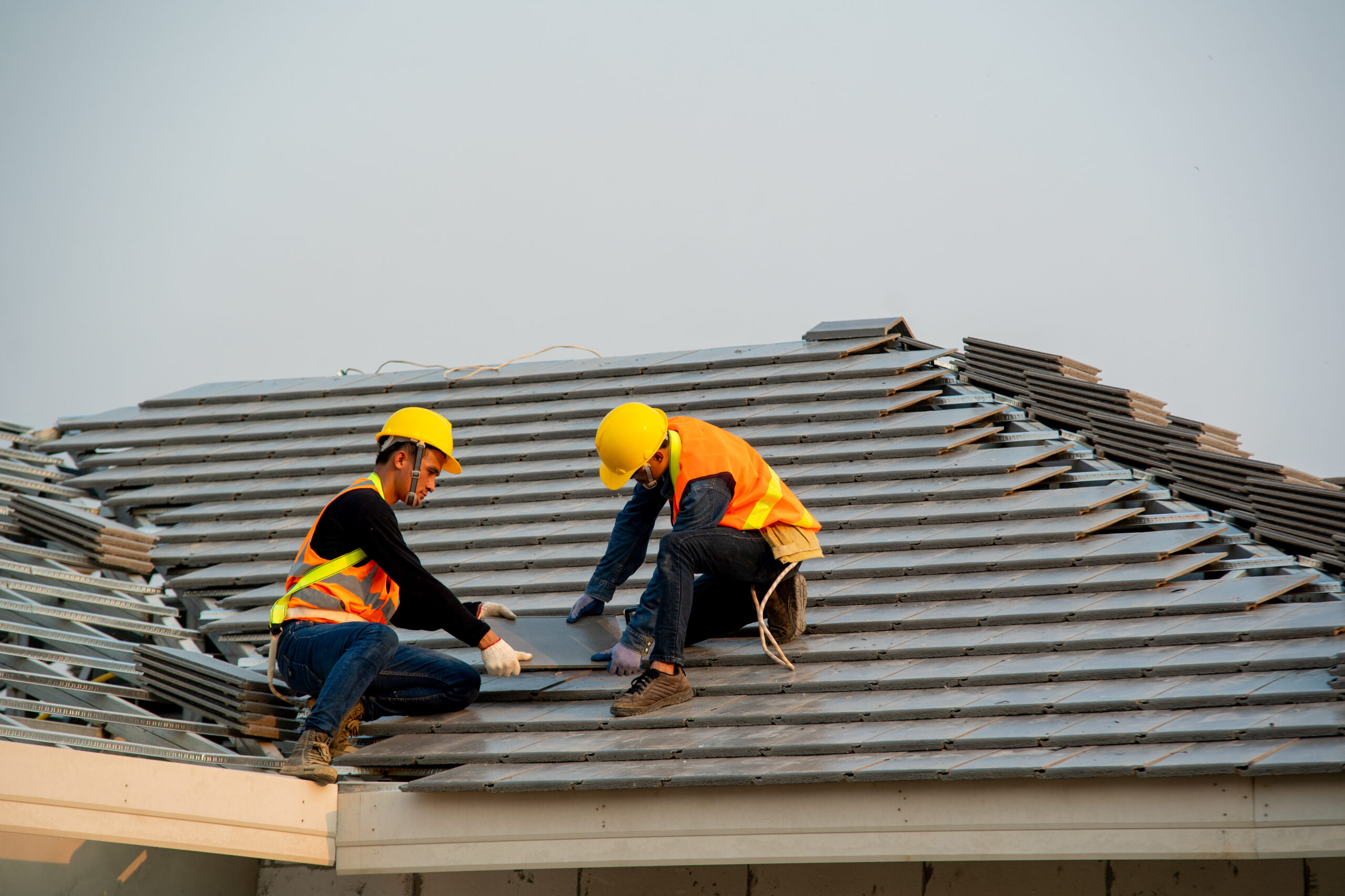 Roofer working on residential roof preparation in Florida before hurricane season – All Phase Roofing